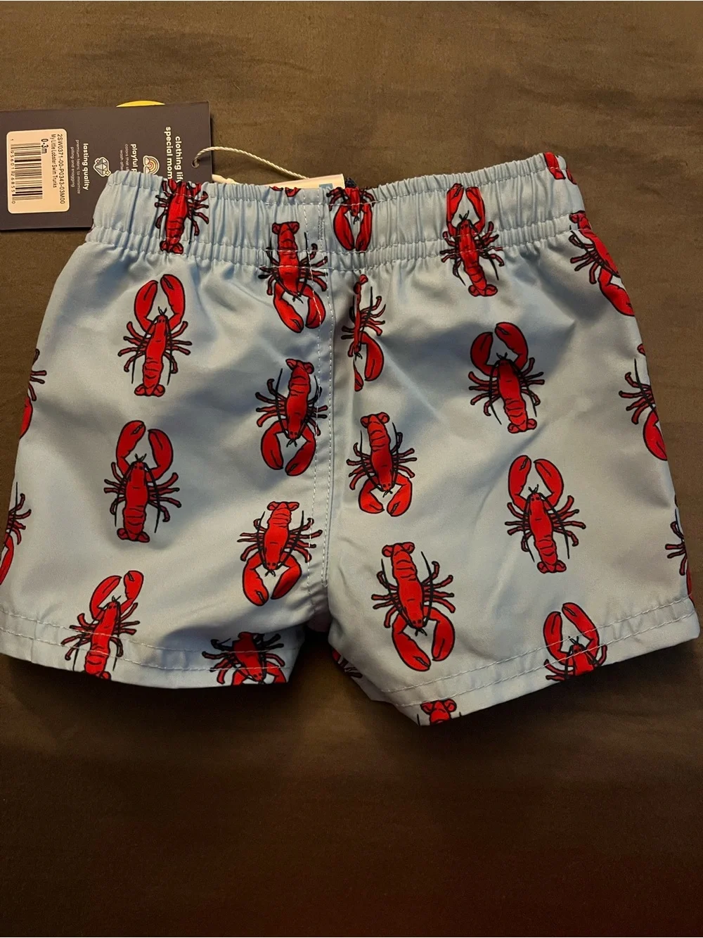 RuffleButts Light Blue Swim Trunks with Red Lobster Print